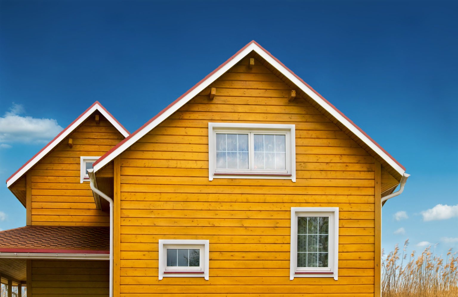 a yellow house with a blue sky