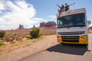 a couple of men on top of a bus