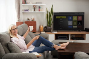 a person sitting on a couch in front of a television