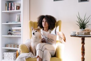 a person reading a book to a dog